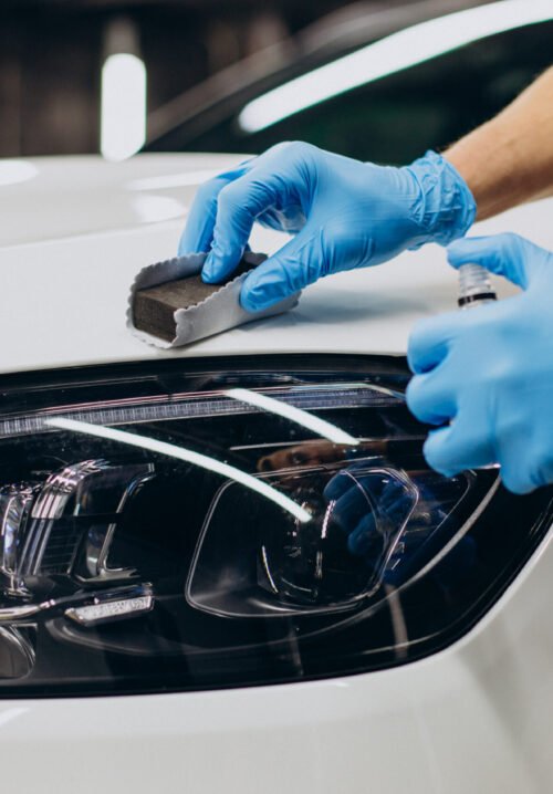Man working car detailing and coating car