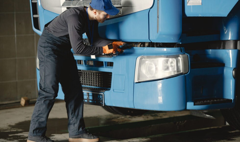 A young worker checks the wheel. Truck malfunction. Service work.